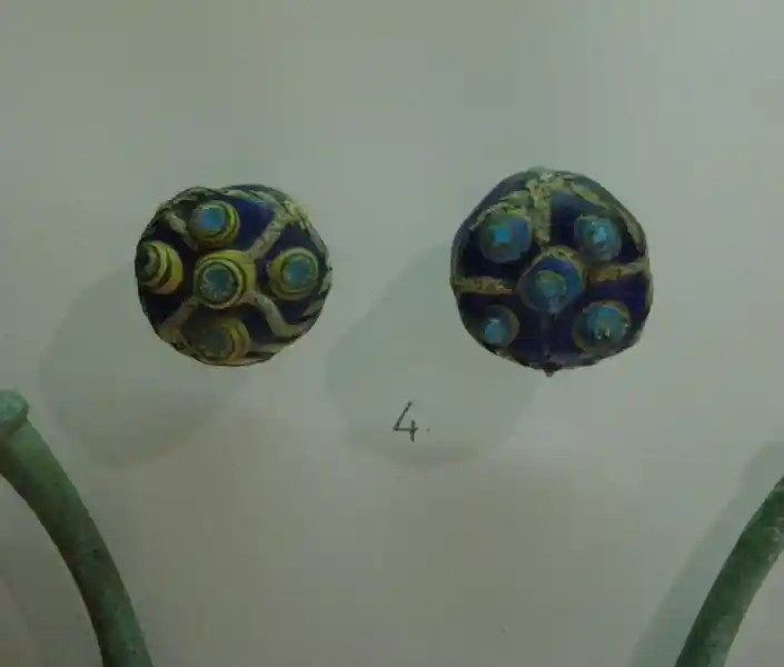 Circular glass buckle with a cross design in the center